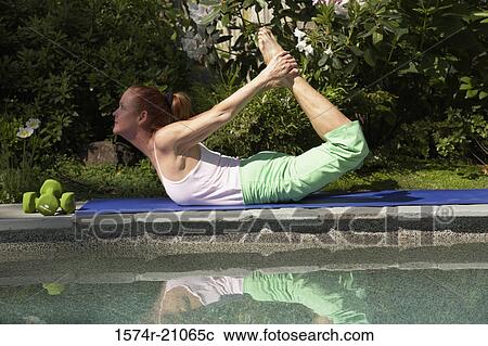 Stock Image - Side profile of a mature woman exercising. Fotosearch