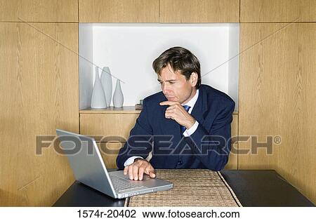 Close-up of a businessman using a laptop View Large Photo Image Stock Image - Close-up of a businessman using a laptop. Fotosearch