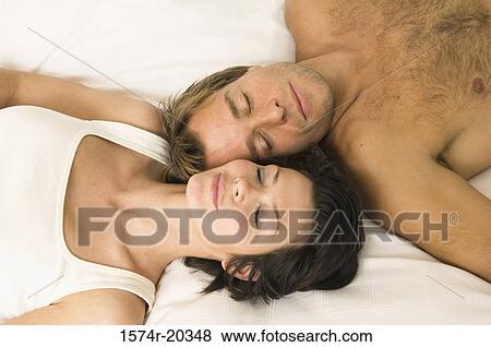 Stock Photo - Close-up of a young couple sleeping in bed. Fotosearch