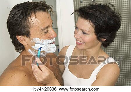 Close-up of a young woman shaving the beard of a young man View Large Photo Image Stock Photograph - Close-up of a young woman shaving the beard of a young man. Fotosearch