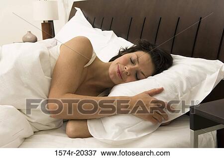 Close-up of a young woman sleeping in the bed View Large Photo Image Stock Photo - Close-up of a young woman sleeping in the bed. Fotosearch