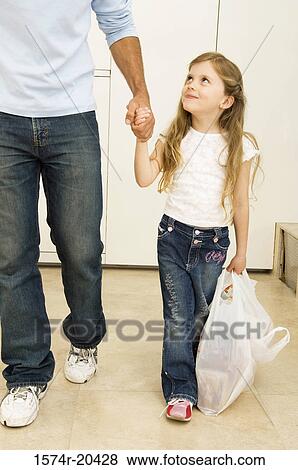 Girl walking with her father View Large Photo Image Stock Photo - Girl walking with her father. Fotosearch