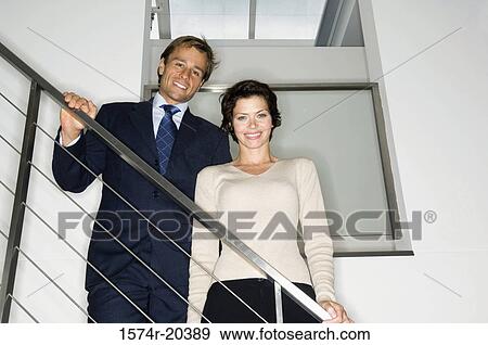 Portrait of a businessman and a businesswoman smiling View Large Photo Image Stock Photo - Portrait of a businessman and a businesswoman smiling. Fotosearch