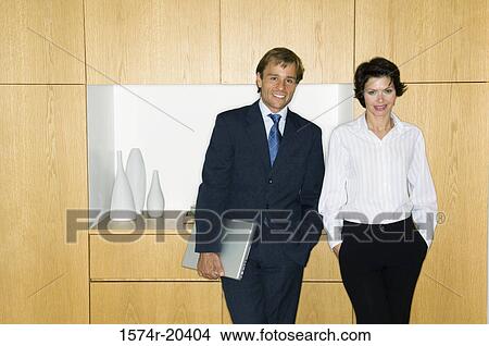 Picture - Portrait of a businessman standing with a businesswoman and smiling. Fotosearch