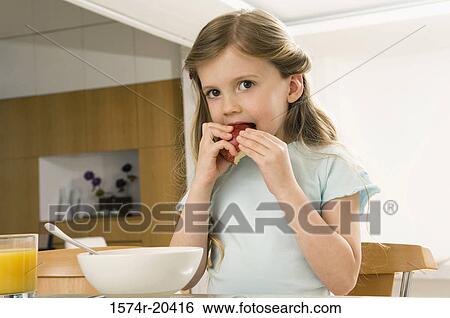 Portrait of a girl eating an apple View Large Photo Image Stock Photograph - Portrait of a girl eating an apple. Fotosearch