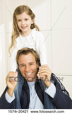 Portrait of a young man carrying his daughter on his shoulders View Large Photo Image Stock Image - Portrait of a young man carrying his daughter on his shoulders. Fotosearch