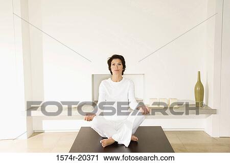 Stock Image - Young woman doing yoga. Fotosearch