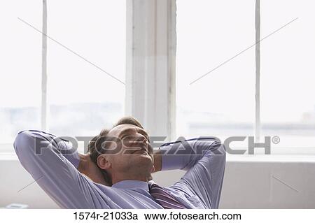 Businessman with his hands behind his head View Large Photo Image Stock Image - Businessman with his hands behind his head. Fotosearch