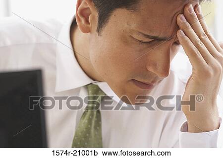 Close-up of a businessman suffering from a headache View Large Photo Image Stock Image - Close-up of a businessman suffering from a headache. Fotosearch