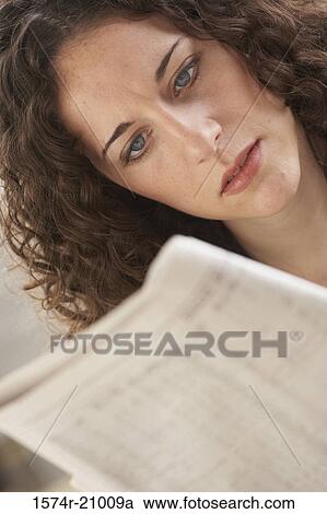 Close-up of a businesswoman reading a newspaper View Large Photo Image Stock Image - Close-up of a businesswoman reading a newspaper. Fotosearch