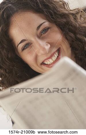 Close-up of a businesswoman reading a newspaper View Large Photo Image Stock Image - Close-up of a businesswoman reading a newspaper. Fotosearch