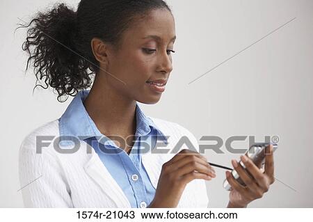 Close-up of a businesswoman using a PDA View Large Photo Image Stock Image - Close-up of a businesswoman using a PDA. Fotosearch