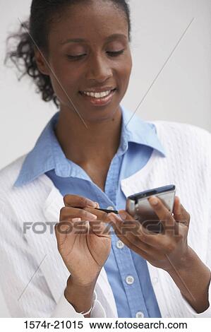 Close-up of a businesswoman using a PDA View Large Photo Image Stock Photography - Close-up of a businesswoman using a PDA. Fotosearch