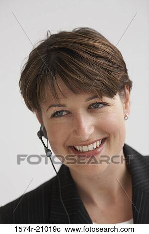Close-up of a businesswoman using a hands free device View Large Photo Image Stock Image - Close-up of a businesswoman using a hands free device. Fotosearch