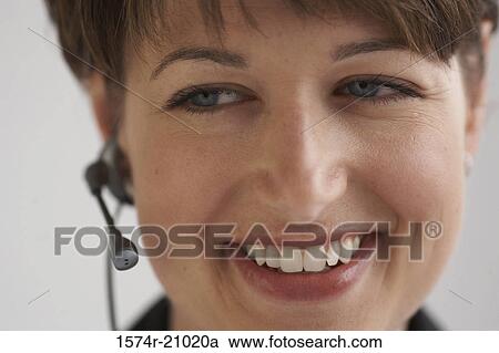 Close-up of a businesswoman using a hands free device View Large Photo Image Stock Image - Close-up of a businesswoman using a hands free device. Fotosearch