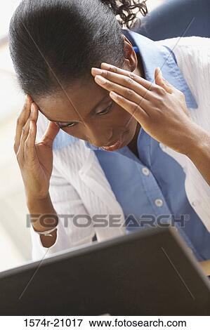High angle view of a businesswoman suffering from a headache View Large Photo Image Stock Photo - High angle view of a businesswoman suffering from a headache. Fotosearch
