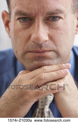 Portrait of a businessman resting his chin on his hands View Large Photo Image Stock Image - Portrait of a businessman resting his chin on his hands. Fotosearch