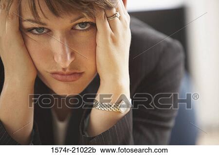 Stock Image - Portrait of a businesswoman looking sad. Fotosearch
