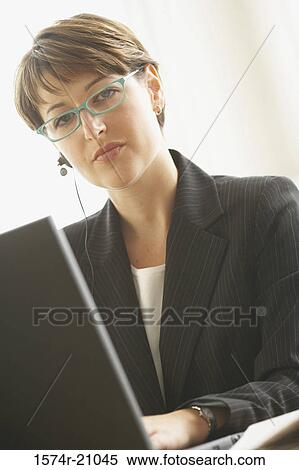 Portrait of a businesswoman using a laptop View Large Photo Image Stock Photography - Portrait of a businesswoman using a laptop. Fotosearch