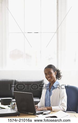 Portrait of a businesswoman working on a laptop View Large Photo Image Stock Image - Portrait of a businesswoman working on a laptop. Fotosearch