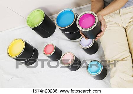 High angle view of a woman sitting with paint cans beside her View Large Photo Image Stock Photograph - High angle view of a woman sitting with paint cans beside her. Fotosearch