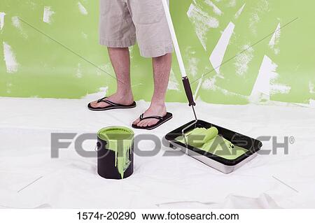 Low section view of a man standing with a paint roller View Large Photo Image Stock Image - Low section view of a man standing with a paint roller. Fotosearch