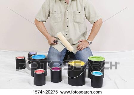 Mid section view of a man holding a paint roller with paint cans in front of him View Large Photo Image Stock Photography - Mid section view of a man holding a paint roller with paint cans in front of him. Fotosearch