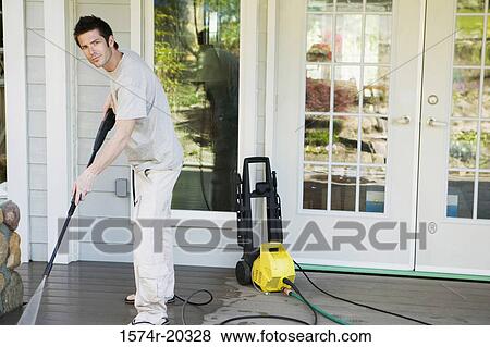 Portrait of a young man cleaning the porch of his house View Large Photo Image Stock Photo - Portrait of a young man cleaning the porch of his house. Fotosearch