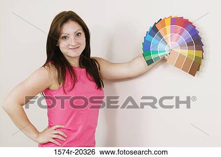 Portrait of a young woman holding color swatches View Large Photo Image Stock Photograph - Portrait of a young woman holding color swatches. Fotosearch
