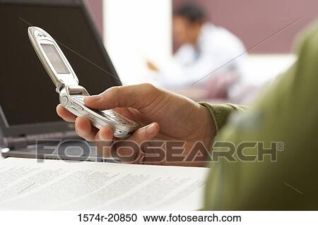 Close-up of a person's hand using a mobile phone View Large Photo Image Stock Image - Close-up of a person's hand using a mobile phone. Fotosearch