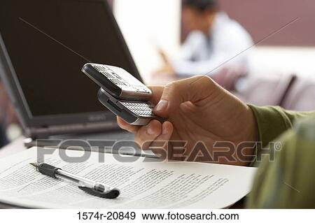 Close-up of a person's hand using a mobile phone View Large Photo Image Stock Photo - Close-up of a person's hand using a mobile phone. Fotosearch