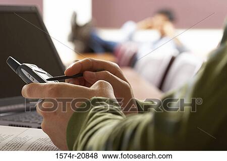 Close-up of a person's hands using a mobile phone with a digitized pen View Large Photo Image Stock Photo - Close-up of a person's hands using a mobile phone with a digitized pen. Fotosearch