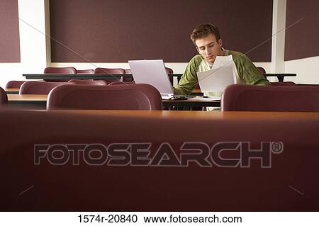 College student sitting in a lecture hall and studying View Large Photo Image Stock Image - College student sitting in a lecture hall and studying. Fotosearch