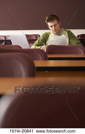 College student sitting in a lecture hall and studying View Large Photo Image Stock Image - College student sitting in a lecture hall and studying. Fotosearch