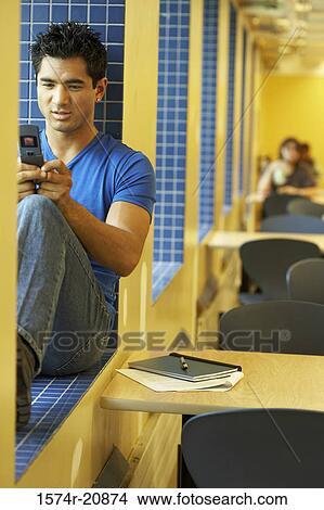 Picture - College student using a mobile phone. Fotosearch