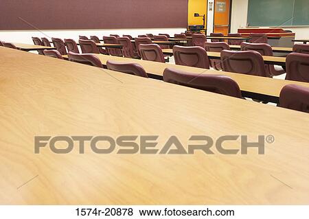Empty tables and chairs in a lecture hall View Large Photo Image Stock Photo - Empty tables and chairs in a lecture hall. Fotosearch