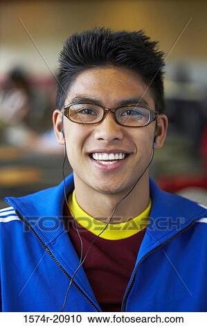 Portrait of a college student wearing headphones and listening to music View Large Photo Image Stock Image - Portrait of a college student wearing headphones and listening to music. Fotosearch