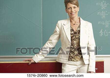 Portrait of a professor standing in front of a blackboard and smiling View Large Photo Image Stock Image - Portrait of a professor standing in front of a blackboard and smiling. Fotosearch
