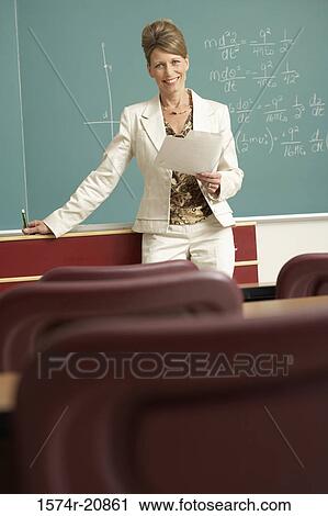 Portrait of a professor standing in front of a blackboard and holding a paper View Large Photo Image Stock Image - Portrait of a professor standing in front of a blackboard and holding a paper. Fotosearch