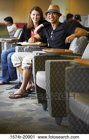Portrait of two college students sitting in a lecture hall and smiling View Large Photo Image Stock Image - Portrait of two college students sitting in a lecture hall and smiling. Fotosearch