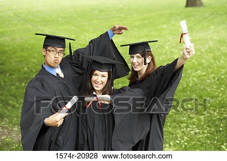 Portrait of two female graduates and a male graduate holding diplomas View Large Photo Image Stock Photo - Portrait of two female graduates and a male graduate holding diplomas. Fotosearch