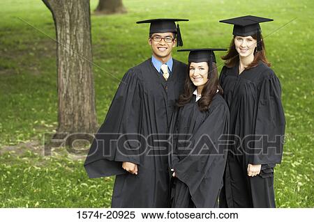 Stock Photography - Portrait of two female graduates and a male graduate smiling. Fotosearch