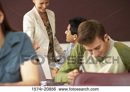 Professor and a college student looking at each other and smiling View Large Photo Image Stock Photograph - Professor and a college student looking at each other and smiling. Fotosearch