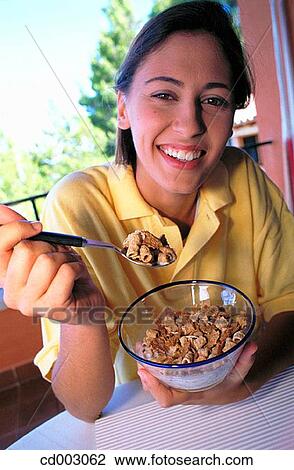 Stock Image - activity, brunette, breakfast, at-home, action. Fotosearch