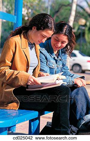 Stock Image - adolescence, bus-stop, brunette, book, activity. Fotosearch