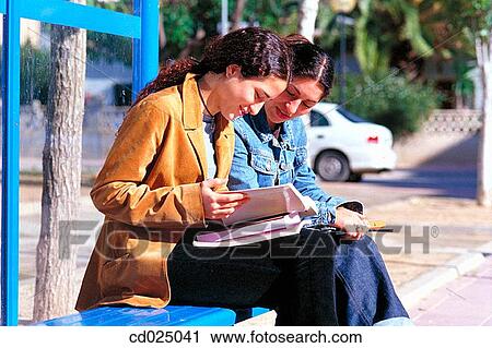 Stock Image - adolescence, College student, bus-stop, book, activity. Fotosearch