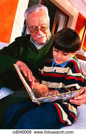 Stock Photo - affection, boy, book, at-home, activity. Fotosearch
