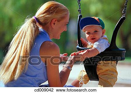 Stock Image - amusement, blond, baby, affection. Fotosearch