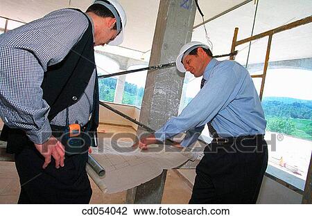 Stock Image - Architect and foreman at construction site. Fotosearch