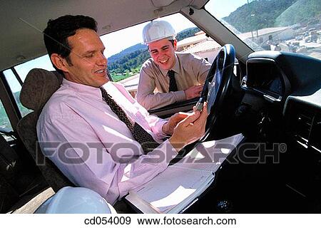 Architect on car using his cell phone View Large Photo Image Stock Photo - Architect on car using his cell phone. Fotosearch